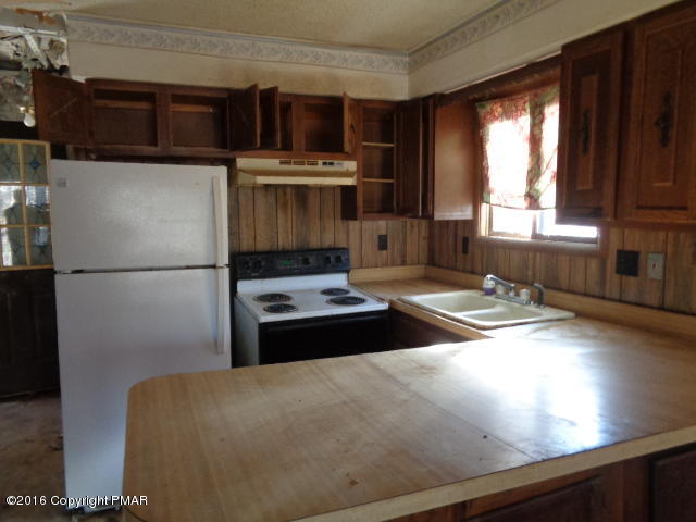 6207 Decker Road Bushkill, PA 18324 - Photo 4 of 6 a kitchen with a refrigerator and a stove