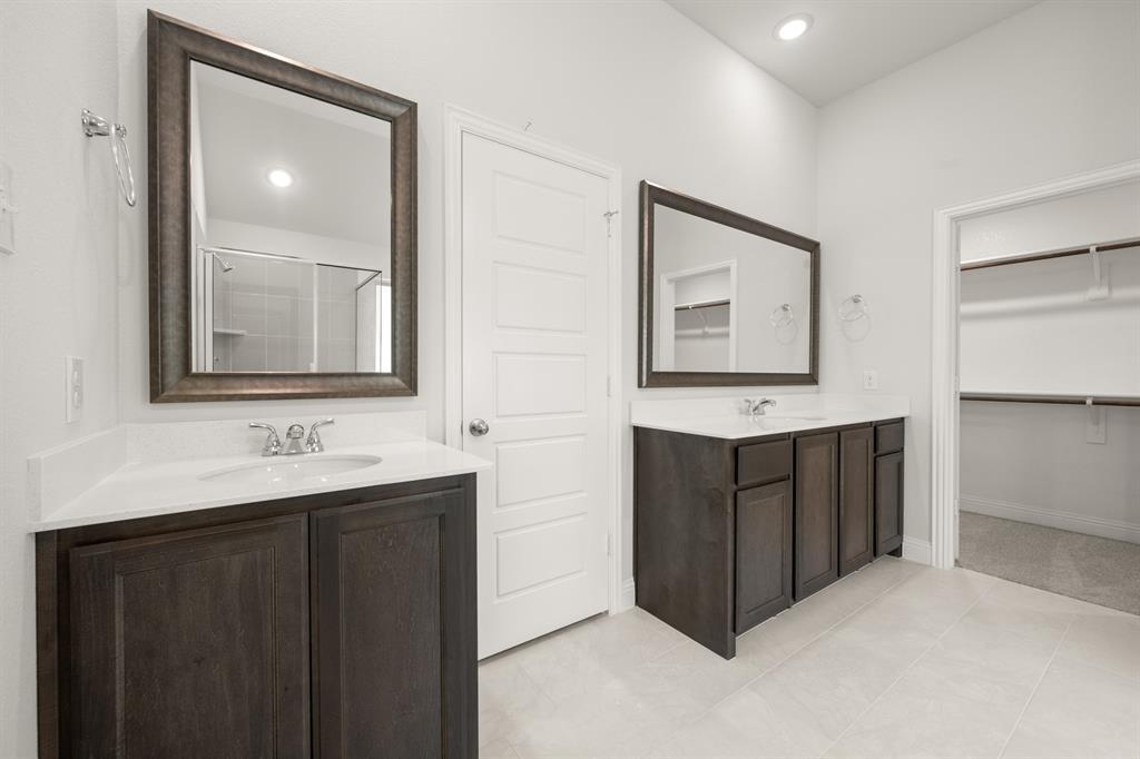 228 Shepards Street Godley, TX 76044 - Photo 11 of 27 a bathroom with a double vanity sink and mirror