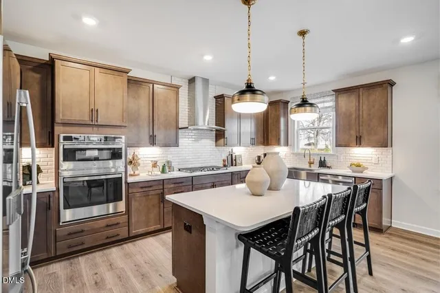 a spacious bedroom with a bed and a chandelier