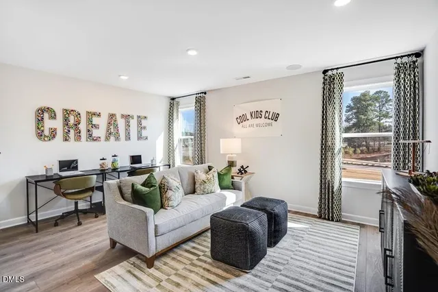 a bathroom with a double vanity sink a mirror and a bathtub