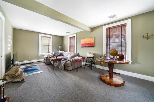 a living room with furniture toys and a window