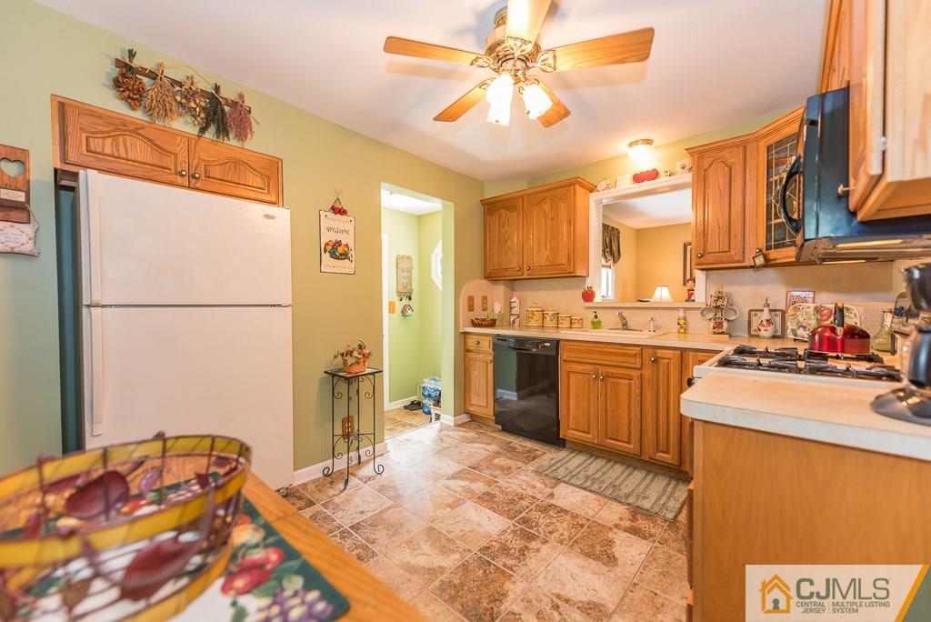 193 New Dover Road Colonia, NJ 07067 - Photo 12 of 25 a kitchen with a refrigerator and a sink
