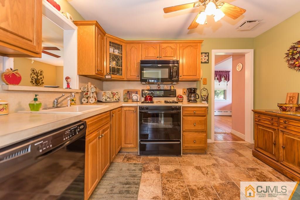 193 New Dover Road Colonia, NJ 07067 - Photo 13 of 25 a kitchen with stainless steel appliances a stove sink and cabinets