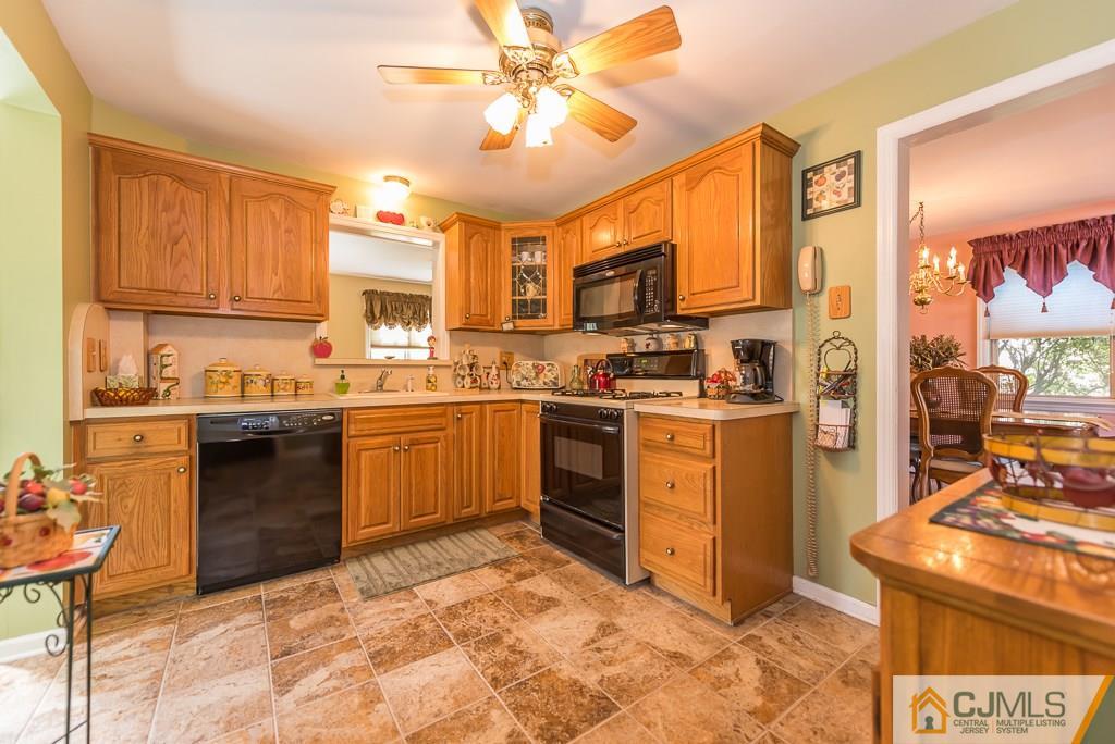 193 New Dover Road Colonia, NJ 07067 - Photo 14 of 25 a kitchen with a stove a sink and a refrigerator