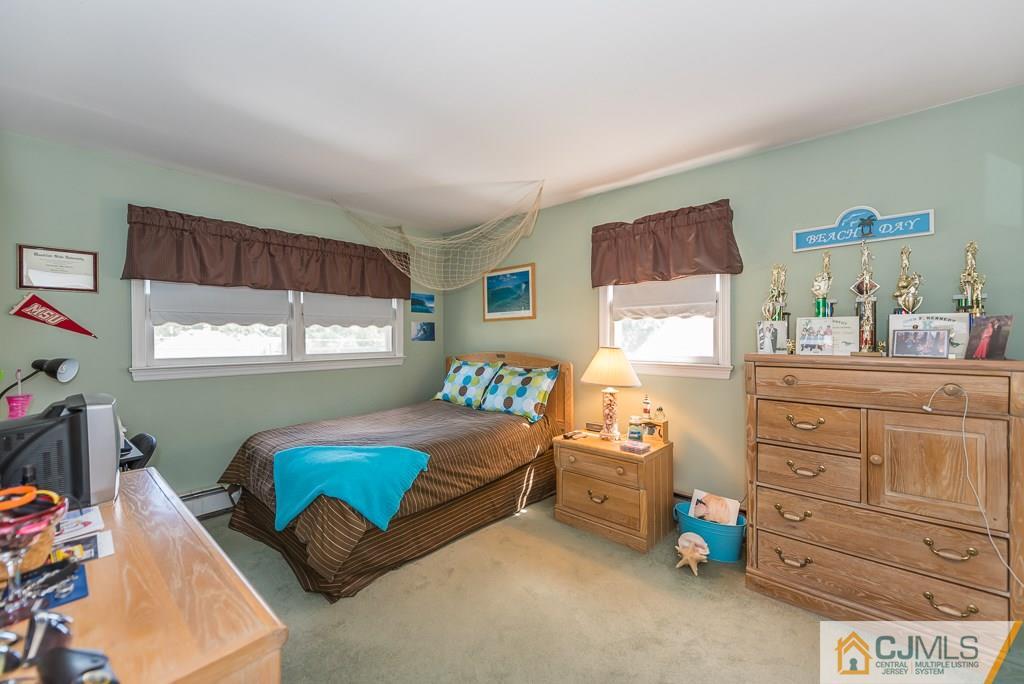 193 New Dover Road Colonia, NJ 07067 - Photo 17 of 25 a bedroom with a bed and a dresser