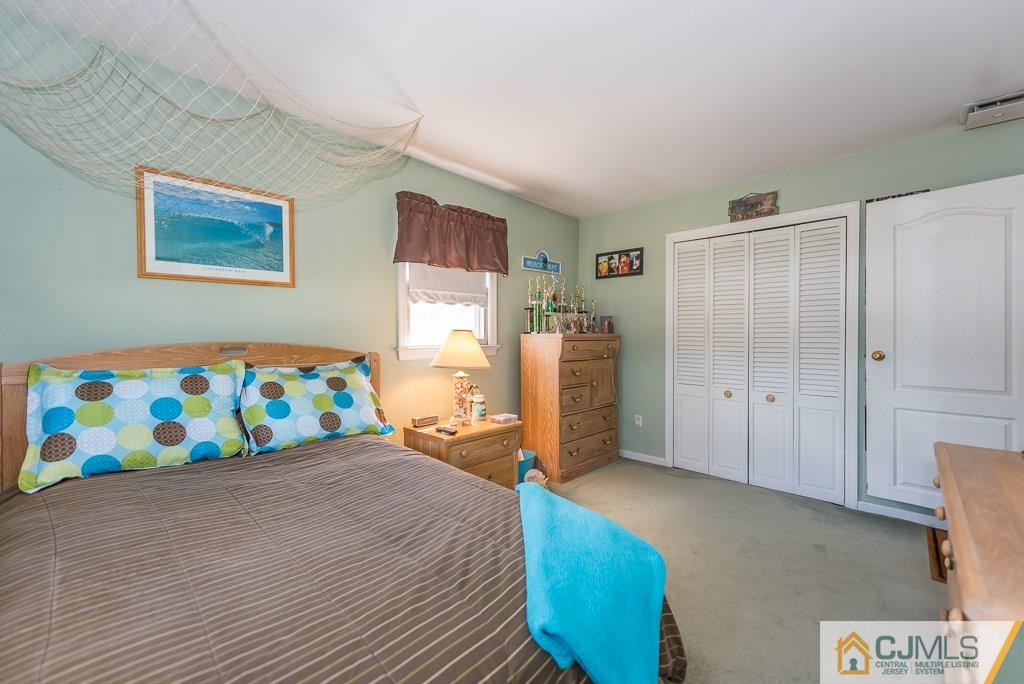 193 New Dover Road Colonia, NJ 07067 - Photo 18 of 25 a bedroom with a bed and a dresser