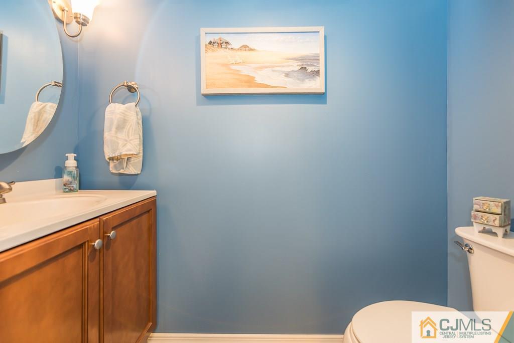 193 New Dover Road Colonia, NJ 07067 - Photo 22 of 25 a bathroom with a toilet sink vanity and mirror
