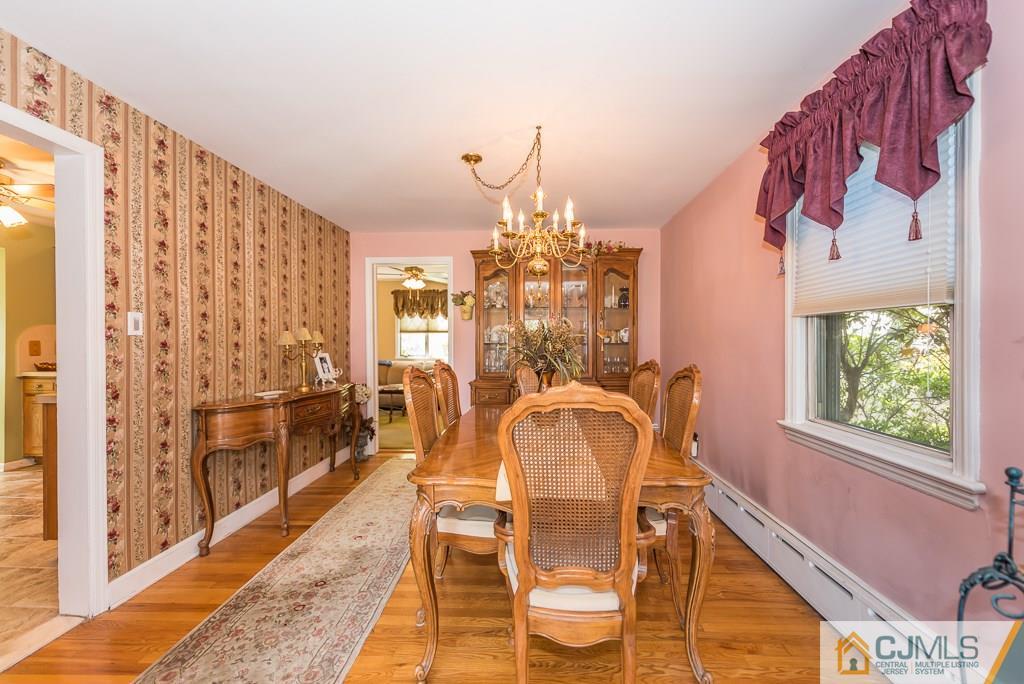 193 New Dover Road Colonia, NJ 07067 - Photo 7 of 25 a dining room with chandelier and wooden floor