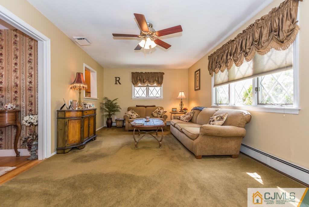 193 New Dover Road Colonia, NJ 07067 - Photo 9 of 25 a living room with furniture a chandelier fan and a window