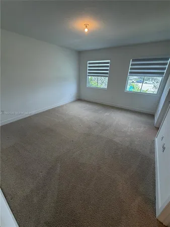 a view of an empty room with windows