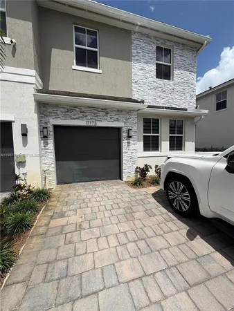 a front view of a house with parking space