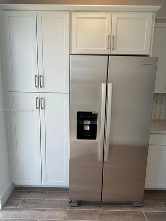 a view of a refrigerator in kitchen