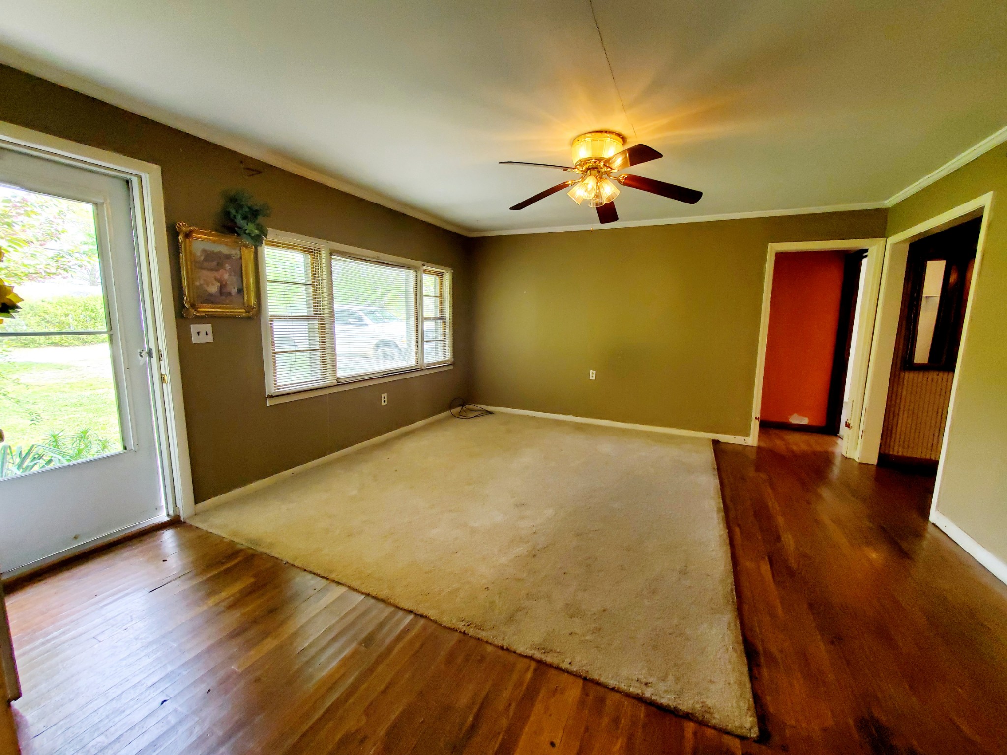 8340 Austin Bottom Road Baxter, TN 38544 - Photo 13 of 32 a view of empty room with wooden floor and fan