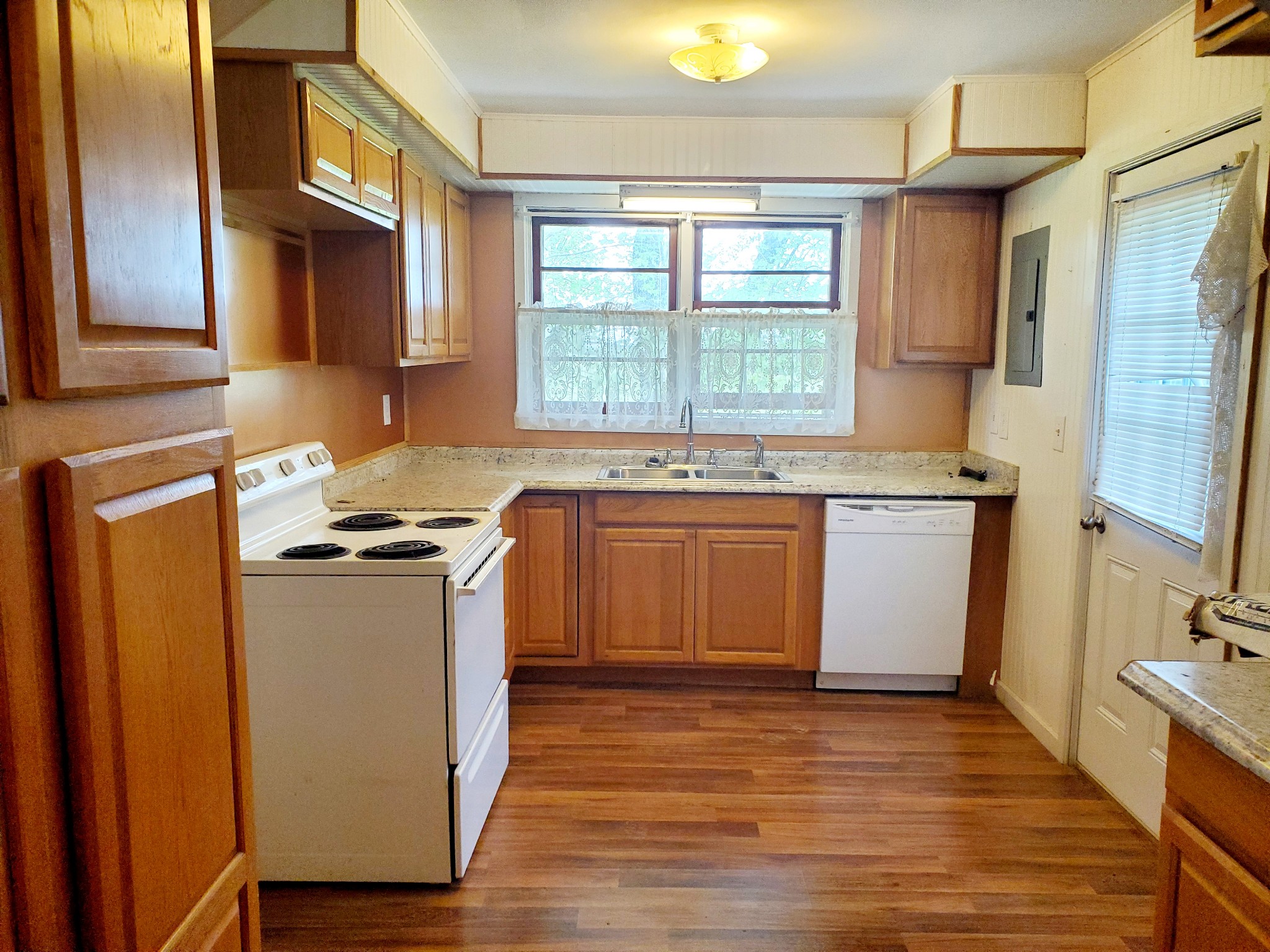 8340 Austin Bottom Road Baxter, TN 38544 - Photo 17 of 32 a kitchen with stainless steel appliances granite countertop a stove a sink dishwasher and a refrigerator with wooden floor