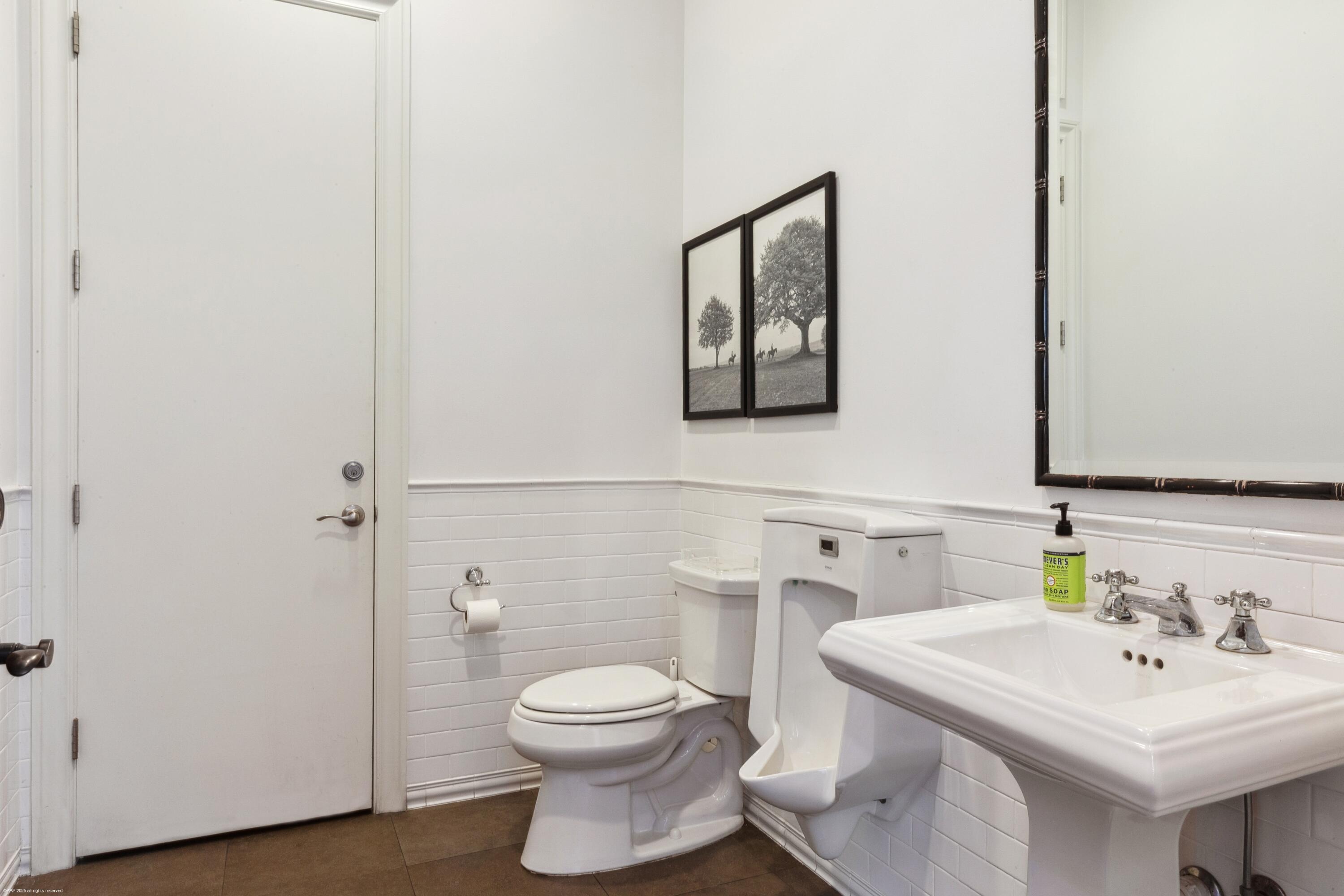 14775 Equestrian Way, Unit STALLS Wellington, FL 33414 - Photo 17 of 19 a bathroom with a toilet sink and mirror