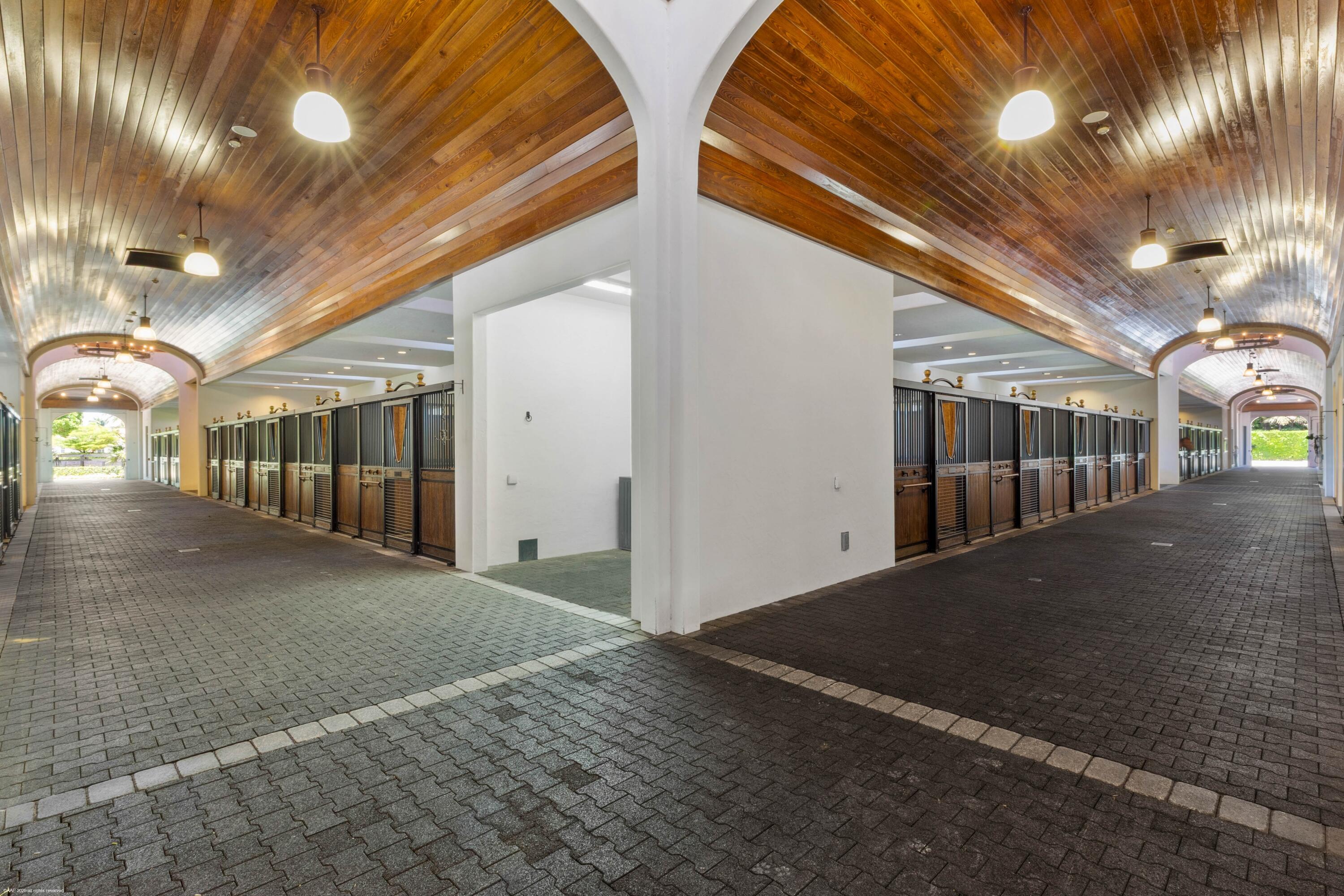 14775 Equestrian Way, Unit STALLS Wellington, FL 33414 - Photo 3 of 19 a view of an chairs under an umbrella