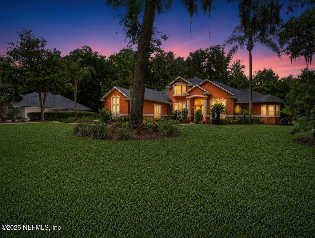 1483 Bridgette Way Fleming Island, FL 32003 - Photo 7 of 63 a front view of a house with a garden