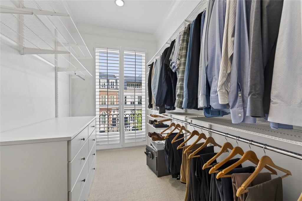 2288 Peachtree Road Northwest, Unit 4 Atlanta, GA 30309 - Photo 25 of 50 a view of walk in closet with clothes and shoes
