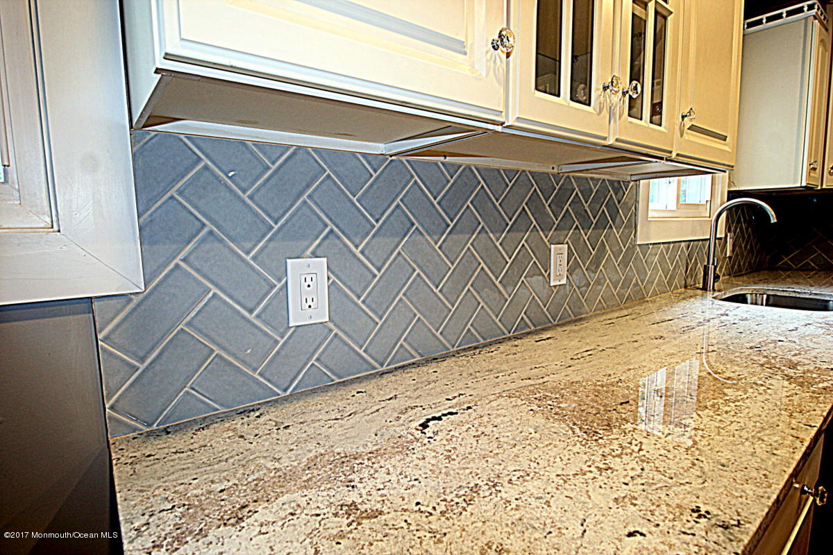 Custom granite and tiled backsplash