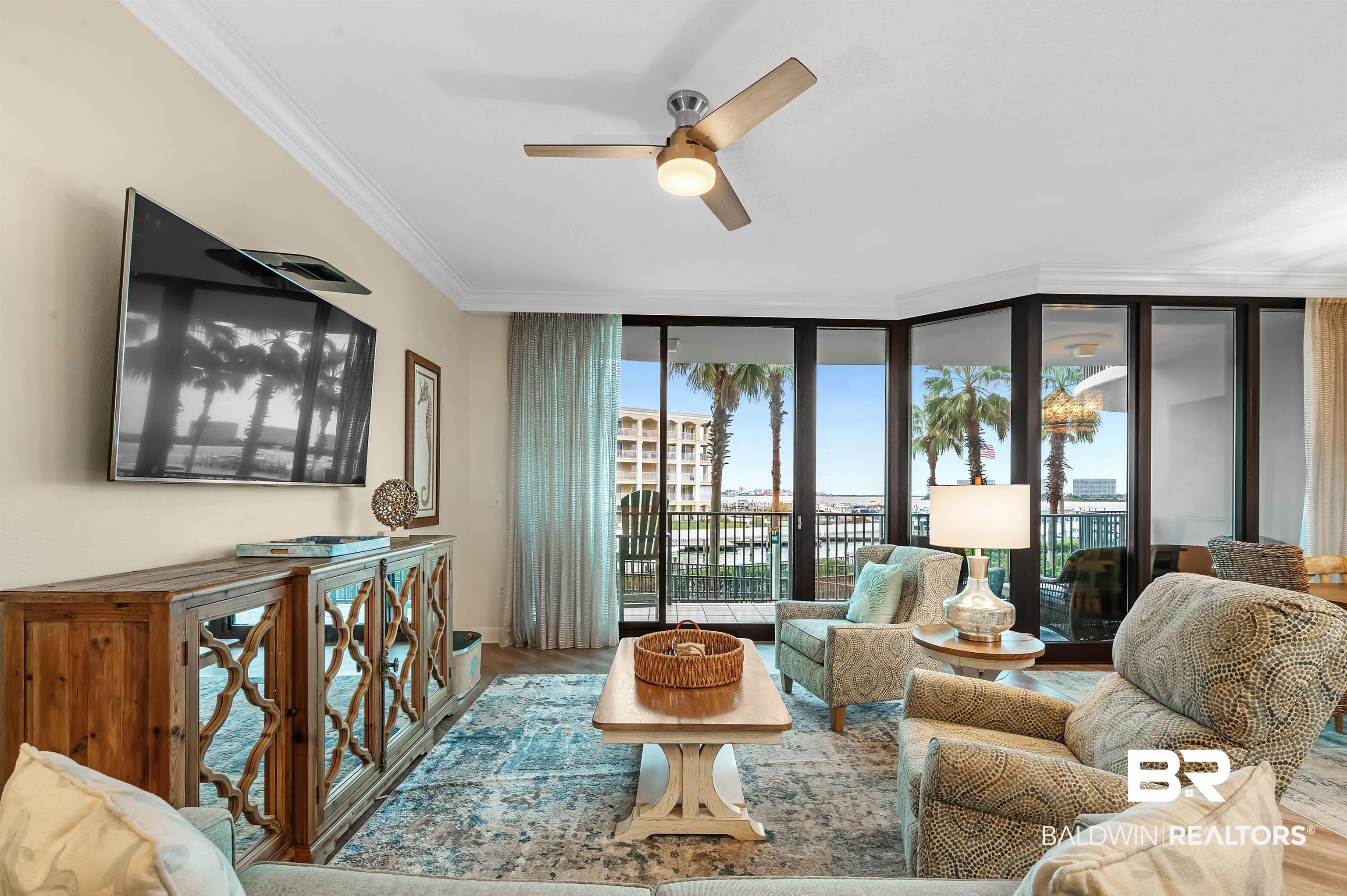 27582 Canal Road, Unit 2104 Orange Beach, AL 36561 - Photo 8 of 35 Living room featuring a wall of windows, crown molding, and hardwood / wood-style floors