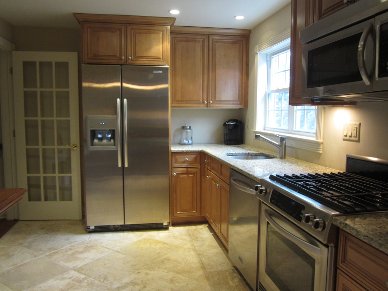 67 New England Avenue, Unit F Summit, NJ 07901 - Photo 2 of 14 a kitchen with granite countertop a refrigerator and a stove top oven