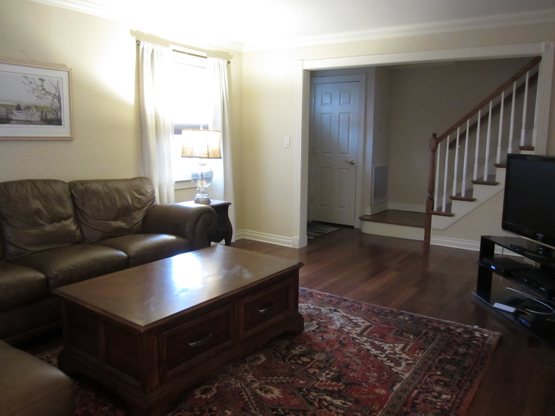 67 New England Avenue, Unit F Summit, NJ 07901 - Photo 5 of 14 a living room with furniture and a flat screen tv