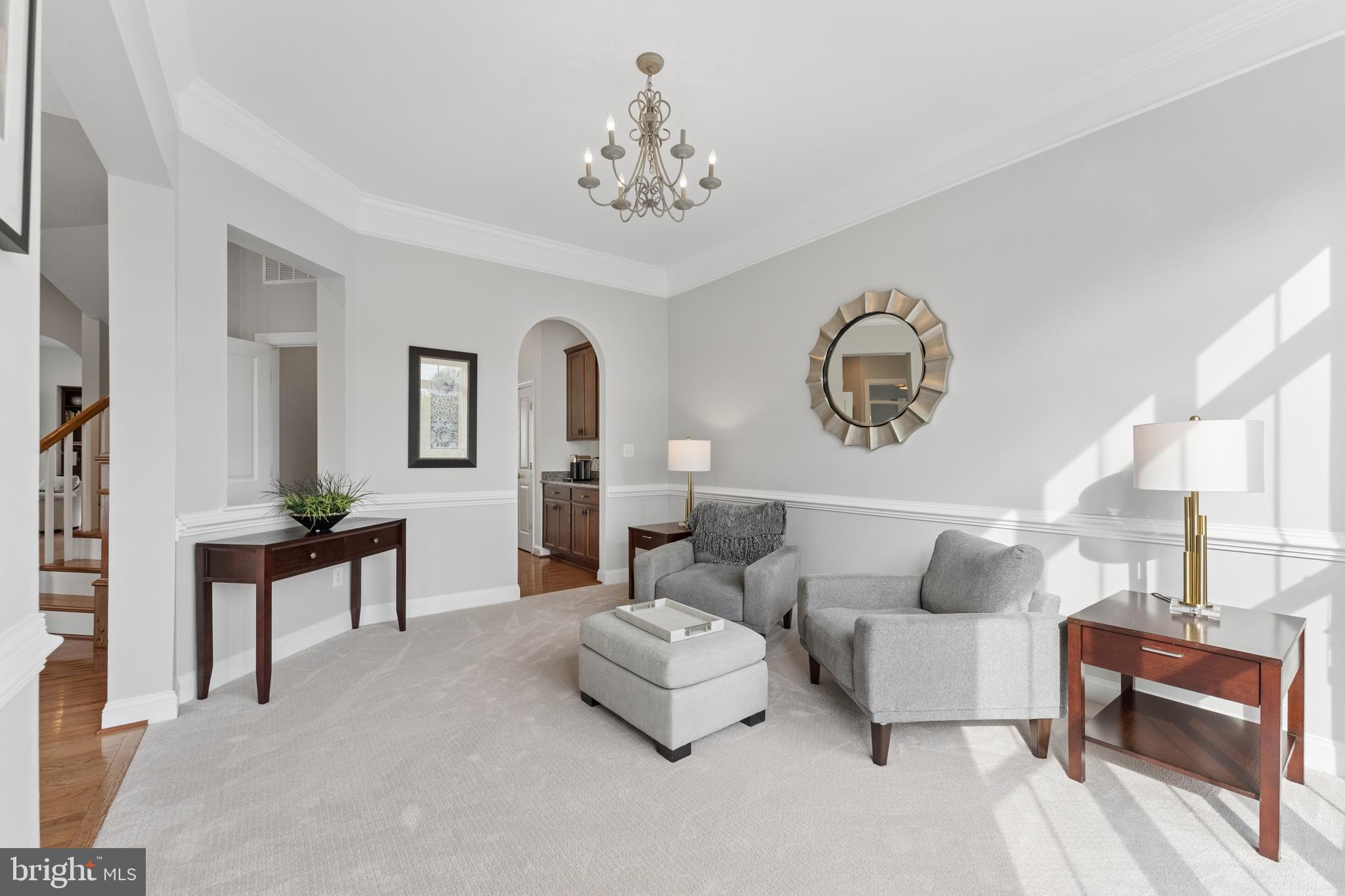 23342 Higbee Lane Brambleton, VA 20148 - Photo 11 of 73 a living room with furniture and a chandelier