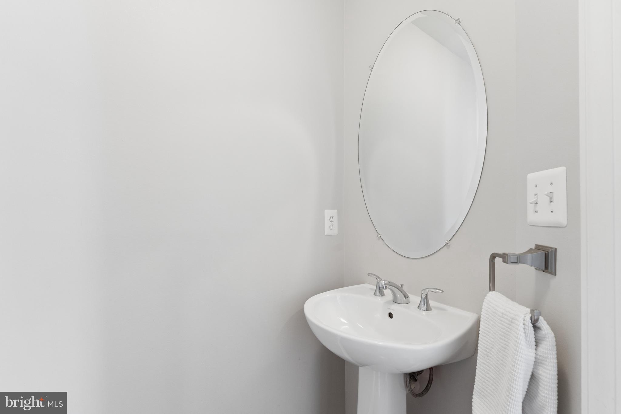 23342 Higbee Lane Brambleton, VA 20148 - Photo 18 of 73 a bathroom with a sink and a mirror