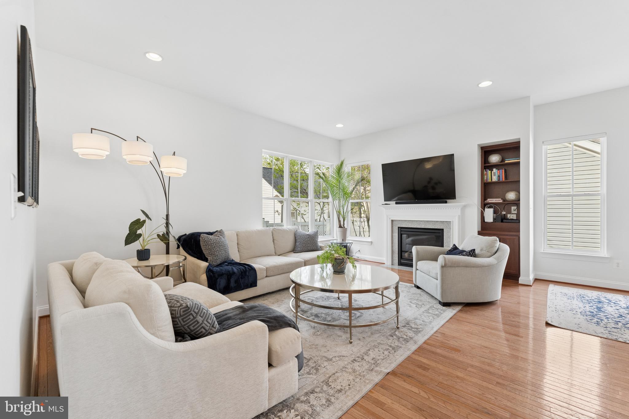 23342 Higbee Lane Brambleton, VA 20148 - Photo 19 of 73 a living room with furniture a flat screen tv and white walls