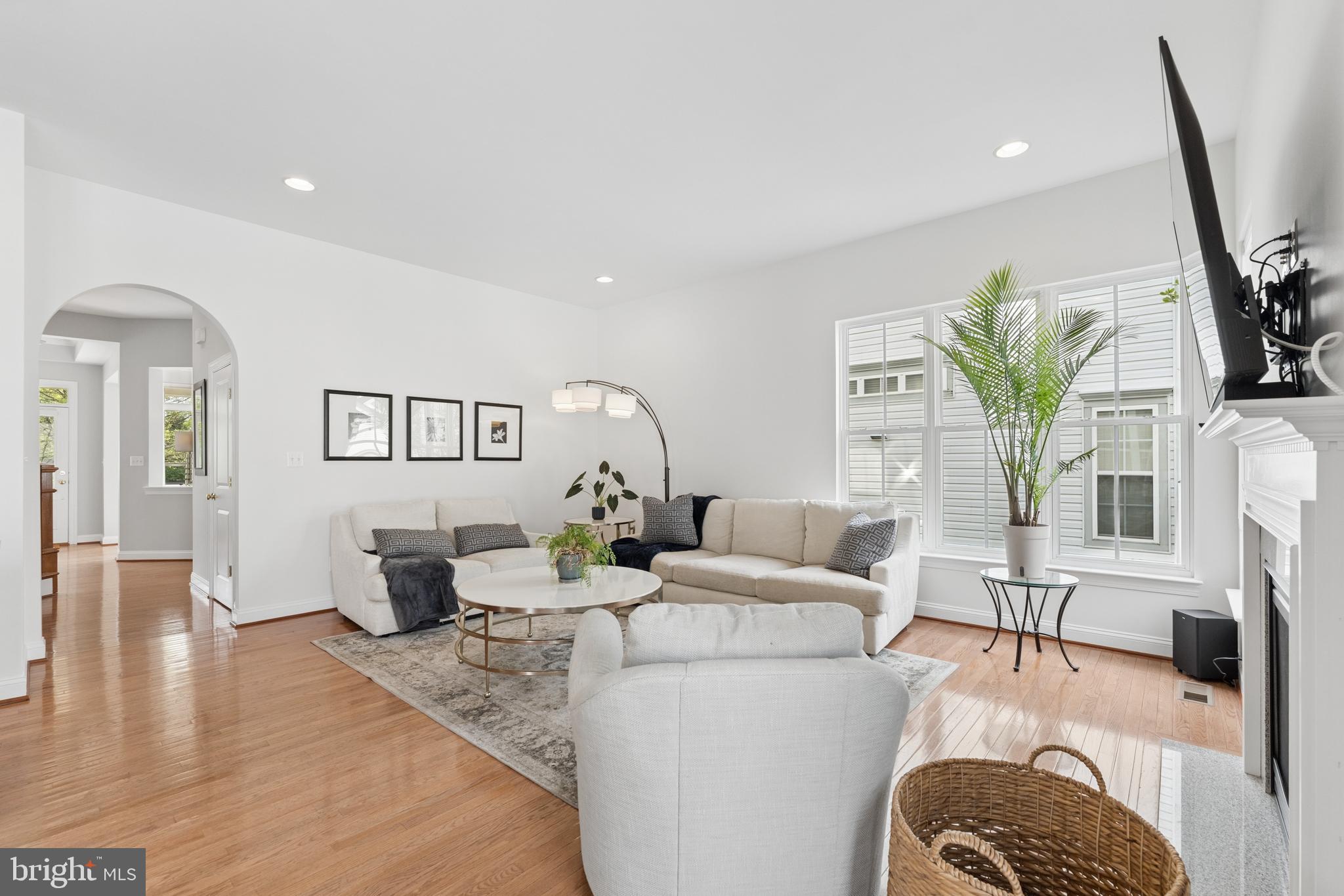 23342 Higbee Lane Brambleton, VA 20148 - Photo 21 of 73 a living room with furniture a fireplace and wooden floor