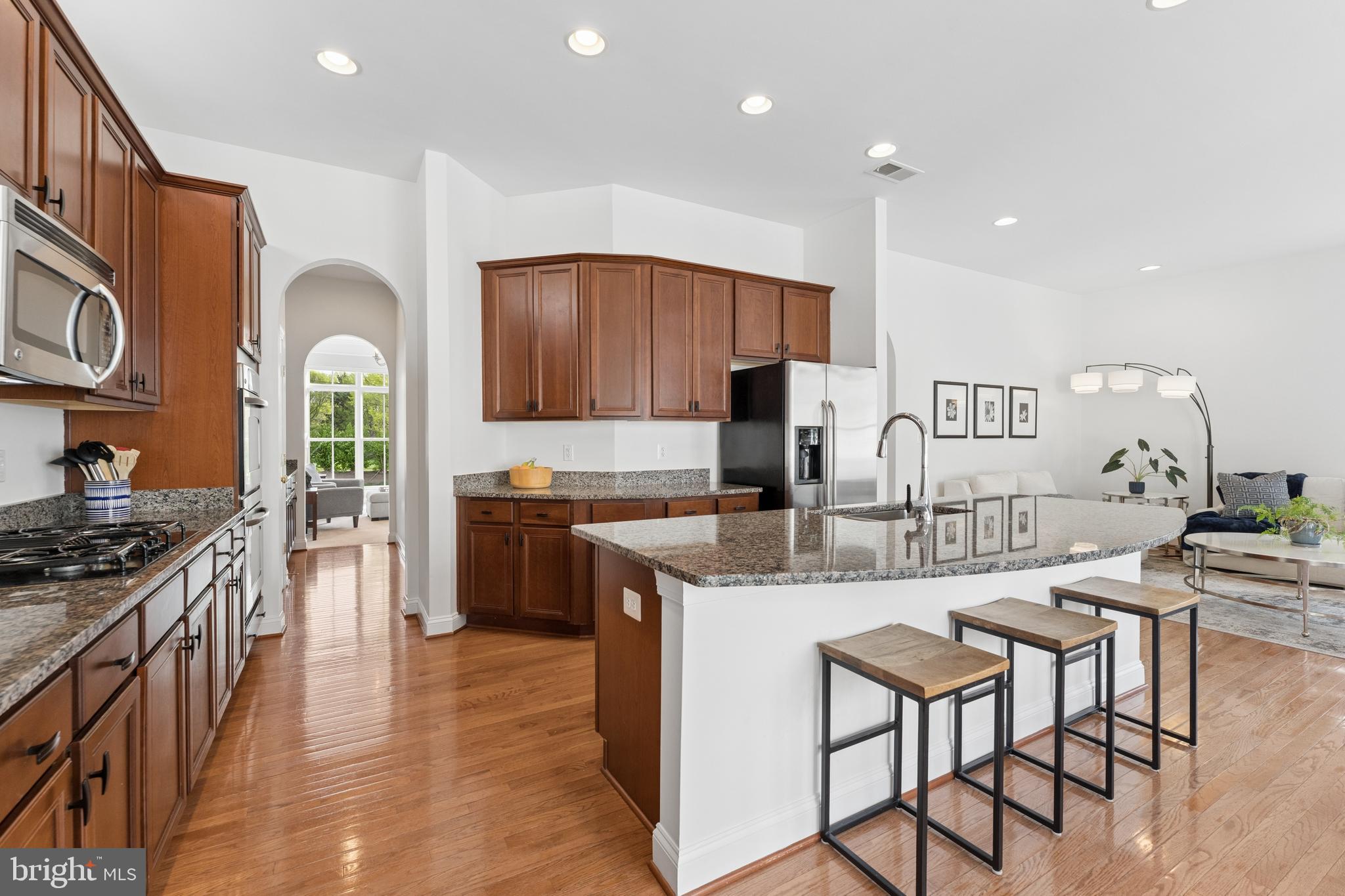 23342 Higbee Lane Brambleton, VA 20148 - Photo 24 of 73 a kitchen with stainless steel appliances granite countertop a stove top oven a sink a counter space and cabinets