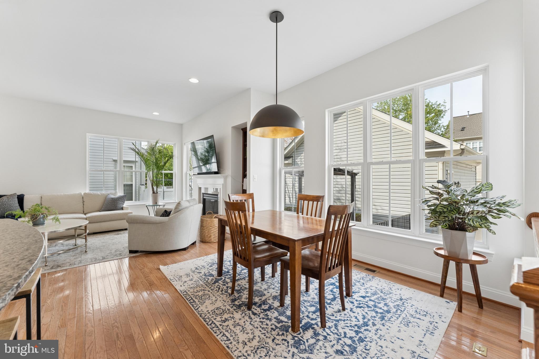 23342 Higbee Lane Brambleton, VA 20148 - Photo 72 of 73 a dining room with furniture a chandelier and wooden floor