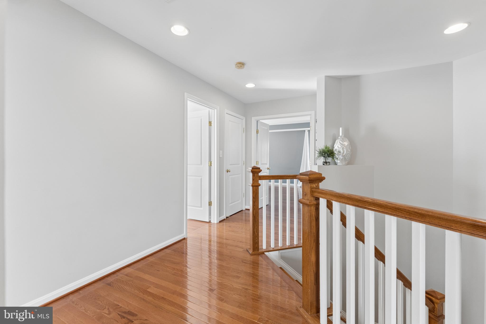 23342 Higbee Lane Brambleton, VA 20148 - Photo 32 of 73 a view of a hallway with wooden floor