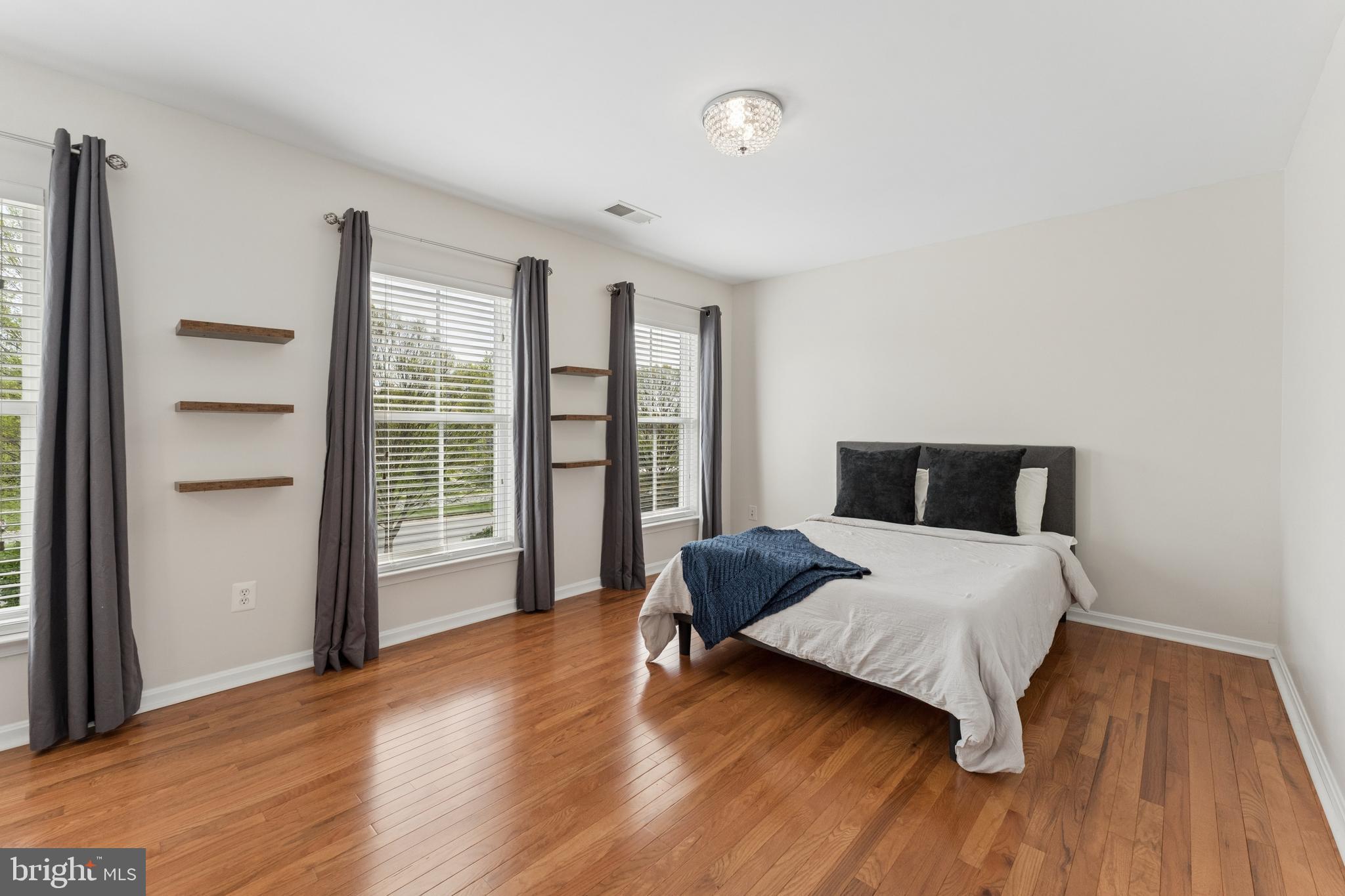 23342 Higbee Lane Brambleton, VA 20148 - Photo 41 of 73 a bedroom with a bed and wooden floor