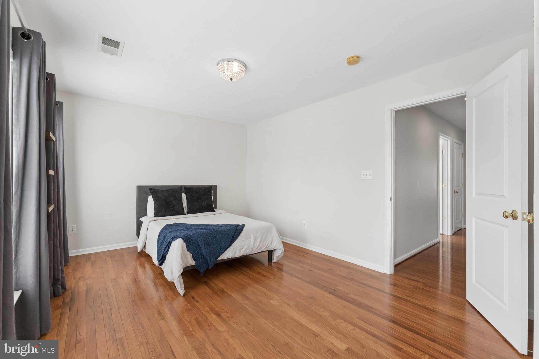 23342 Higbee Lane Brambleton, VA 20148 - Photo 43 of 73 a bedroom with wooden floor and a bed