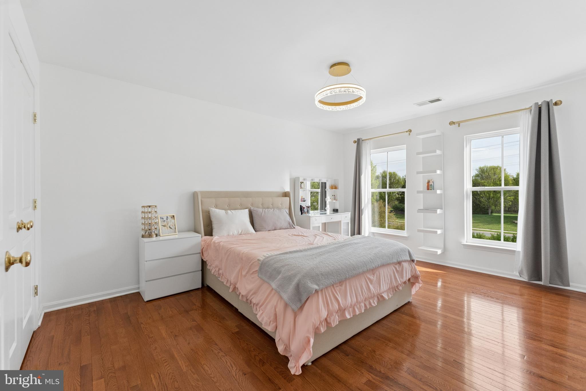 23342 Higbee Lane Brambleton, VA 20148 - Photo 44 of 73 a bedroom with a bed and large windows