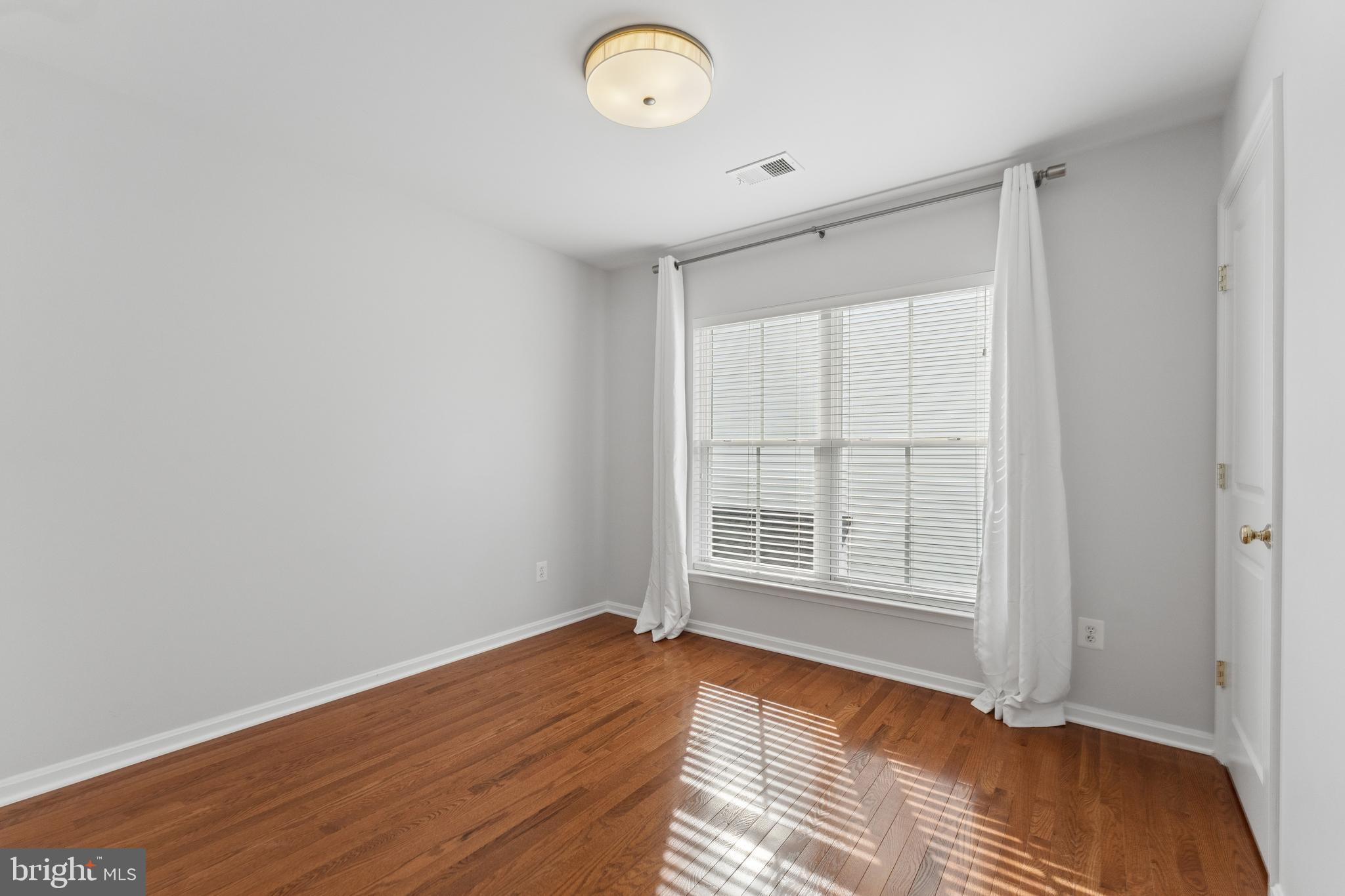 23342 Higbee Lane Brambleton, VA 20148 - Photo 46 of 73 an empty room with wooden floor and windows