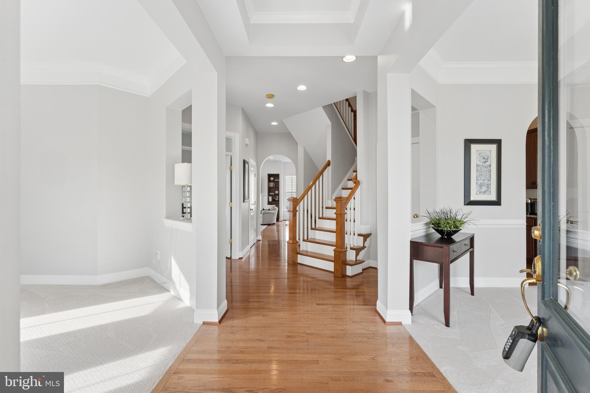 23342 Higbee Lane Brambleton, VA 20148 - Photo 5 of 73 a view of an entryway and livingroom with furniture