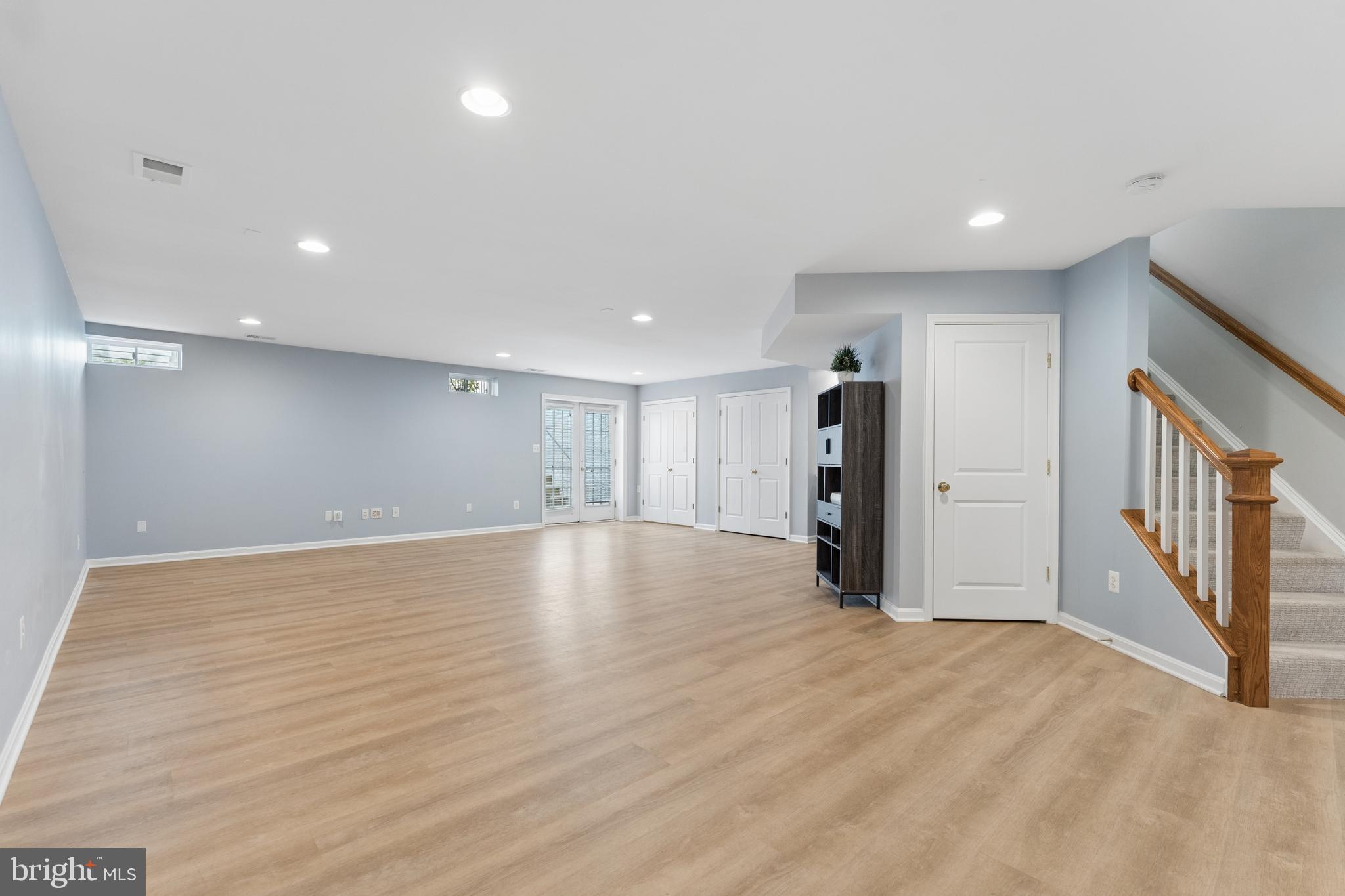 23342 Higbee Lane Brambleton, VA 20148 - Photo 52 of 73 a view of an empty room with wooden floor and stairs