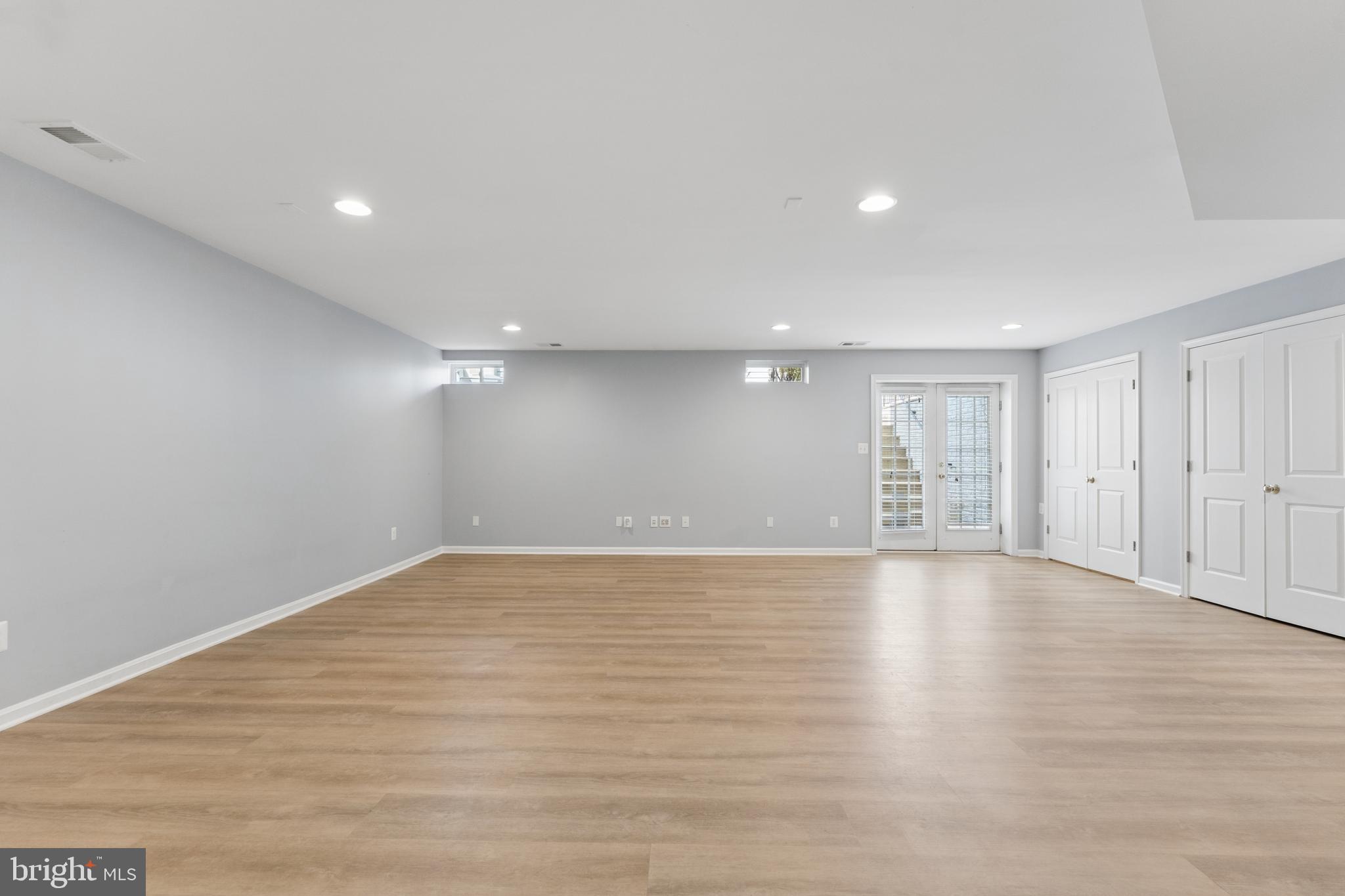 23342 Higbee Lane Brambleton, VA 20148 - Photo 53 of 73 a view of an empty room with wooden floor and a window