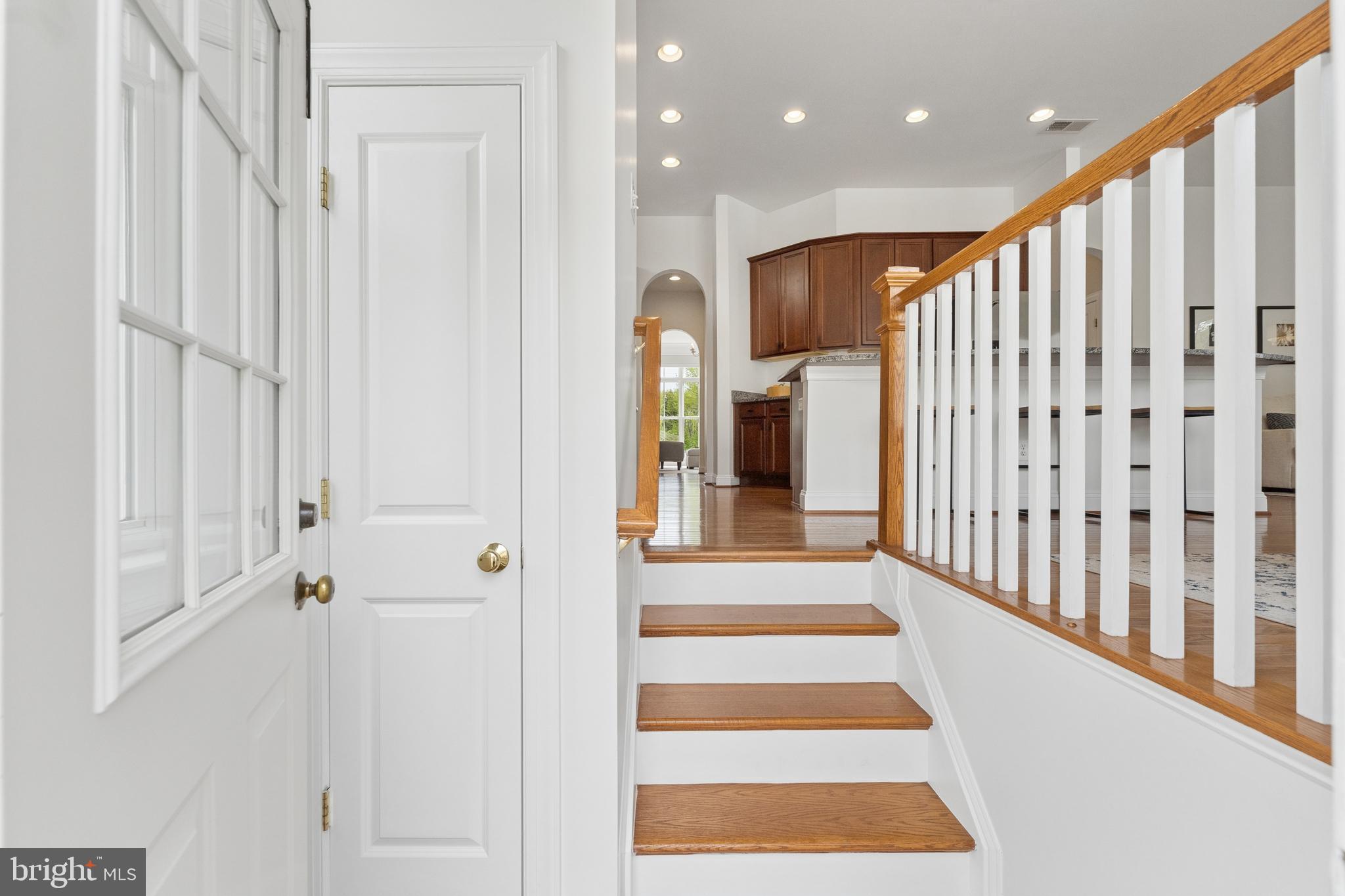 23342 Higbee Lane Brambleton, VA 20148 - Photo 64 of 73 a view of a hallway with wooden floor and windows