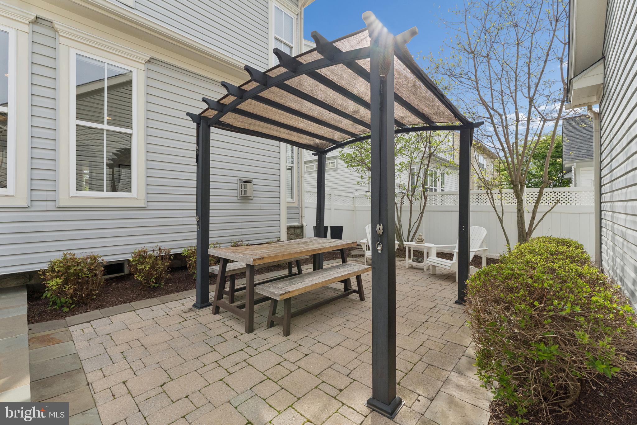 23342 Higbee Lane Brambleton, VA 20148 - Photo 66 of 73 a backyard of a house with barbeque oven table and chairs