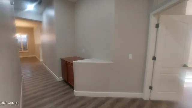 a view of a room with wooden floor and windows