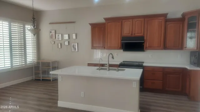 a kitchen with a sink cabinets and wooden floor