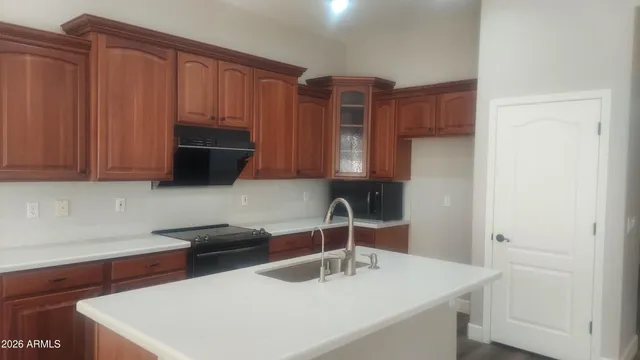 a kitchen with stainless steel appliances a sink a stove and cabinets