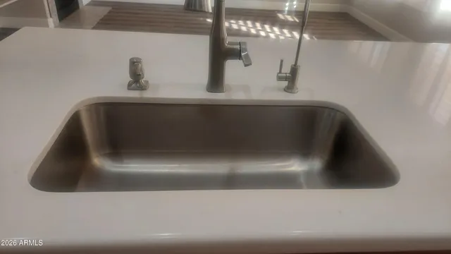 an empty room with wooden floor and windows in it