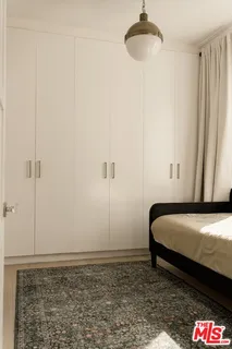 a bedroom with a bed and a ceiling fan