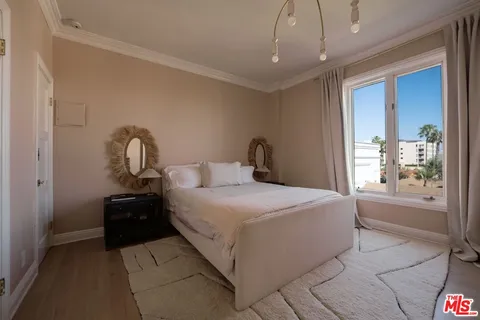 a bedroom with a large bed and a window