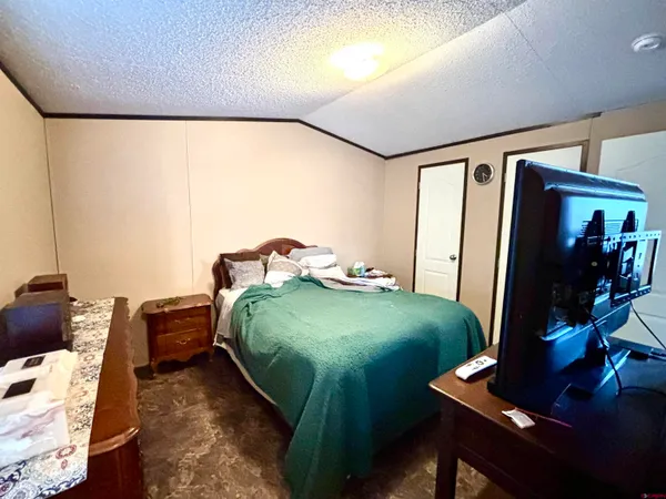 a bedroom with a bed and a desk