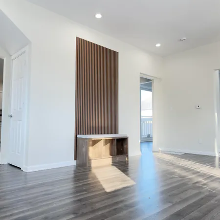 a view of empty room with wooden floor